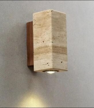 Stone wall sconce with a downward-facing light.